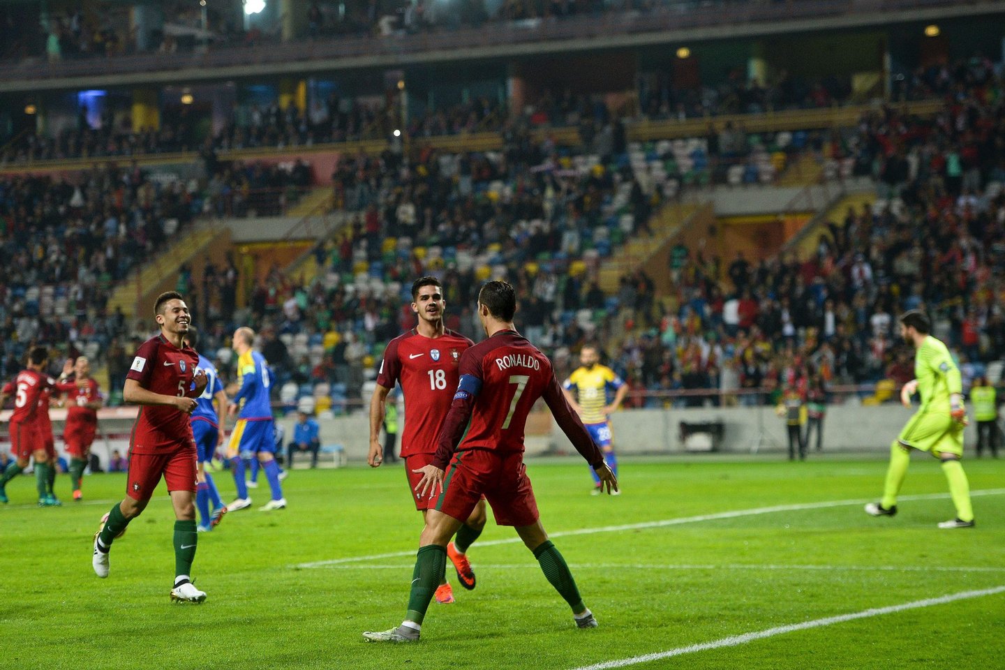 Portugal's forward Cristiano Ronaldo (C) celebrates with his teammates after scoring a goal during the WC 2018 football qualification match between Portugal and Andorra at the Municipal de Arouca stadium in Aveiro on October 7, 2016. / AFP / PATRICIA DE MELO MOREIRA (Photo credit should read PATRICIA DE MELO MOREIRA/AFP/Getty Images)