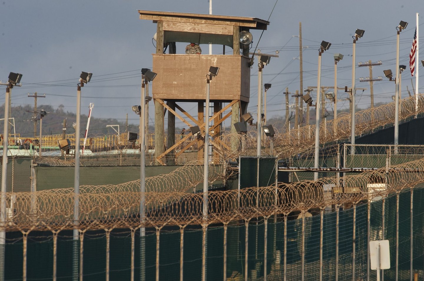 In this photo reviewed by US military officials, a US military member mans one of the watch towers at Camp Delta at the US Detention Center in Guantanamo Bay, Cuba on March 30, 2010. AFP Photo/Paul J. Richards (Photo credit should read PAUL J. RICHARDS/AFP/Getty Images)