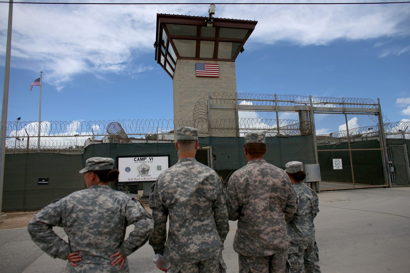 GUANTANAMO BAY, CUBA - JUNE 25: (EDITORS NOTE: Image has been reviewed by the U.S. Military prior to transmission.) Military officers stand at the entrance to Camp VI and V at the U.S. military prison for 'enemy combatants' on June 25, 2013 in Guantanamo Bay, Cuba. President Barack Obama has recently spoken again about closing the prison which has been used to hold prisoners from the invasion of Afghanistan and the war on terror since early 2002. (Photo by Joe Raedle/Getty Images)