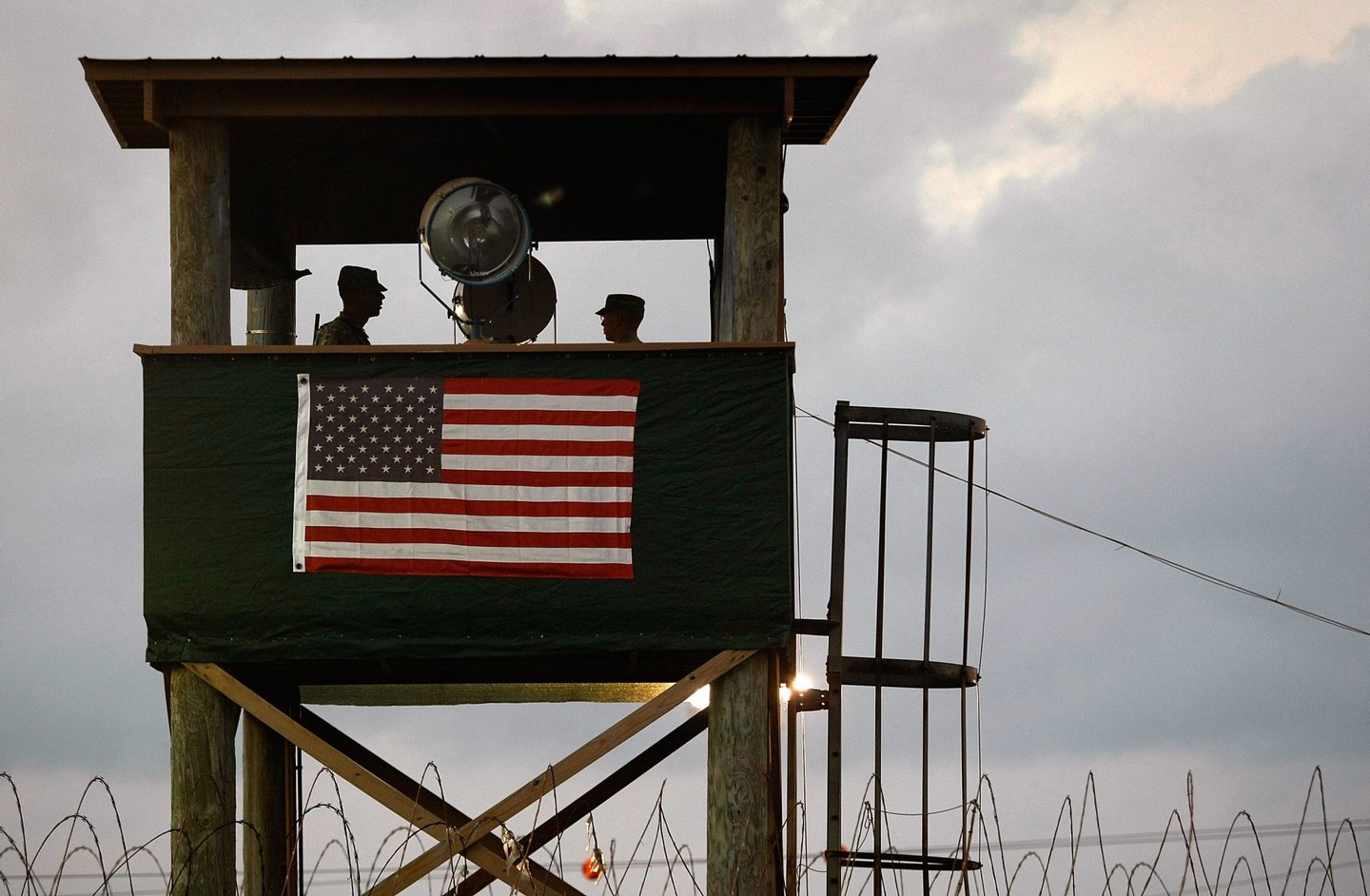 GUANTANAMO BAY, CUBA - MARCH 30: (EDITORS NOTE: Image has been reviewed by the U.S. Military prior to transmission.) U.S. Army soldiers stand watch in a guard tower at Camp Delta in the Guantanamo Bay detention center on March 30, 2010 in Guantanamo Bay, Cuba. U.S. President Barack Obama pledged to close the prison by early 2010 but has struggled to transfer, try or release the remaining detainees from the facility, located on the U.S. Naval Base at Guantanamo Bay, Cuba. (Photo by John Moore/Getty Images)