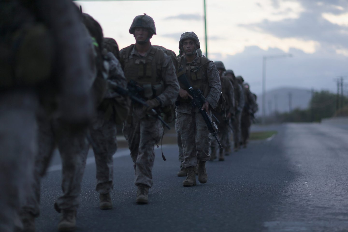 GUANTANAMO BAY, CUBA - JUNE 27: (EDITORS NOTE: Image has been reviewed by the U.S. Military prior to transmission.) U.S. Marines conduct a road march in the early morning on June 27, 2013 in Guantanamo Bay, Cuba.The U.S. Naval Station at Guantanamo Bay, houses the American detention center for 'enemy combatants'. President Barack Obama has recently spoken again about closing the prison which has been used to hold prisoners from the invasion of Afghanistan and the war on terror since early 2002. (Photo by Joe Raedle/Getty Images)