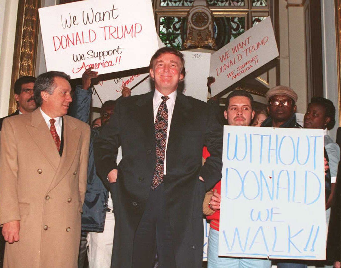 NEW YORK, NY - DECEMBER 21: US business tycoon Donald Trump(C) enters the PLaza Hotel in New York past supporters 21 December 1994. Hundreds of supporters showed up at a news conference where Trump denied a New York newspaper report that the Sultan of Brunei had bid 300 million USD to buy the Manhattan hotel. (Photo credit should read DON EMMERT/AFP/Getty Images)