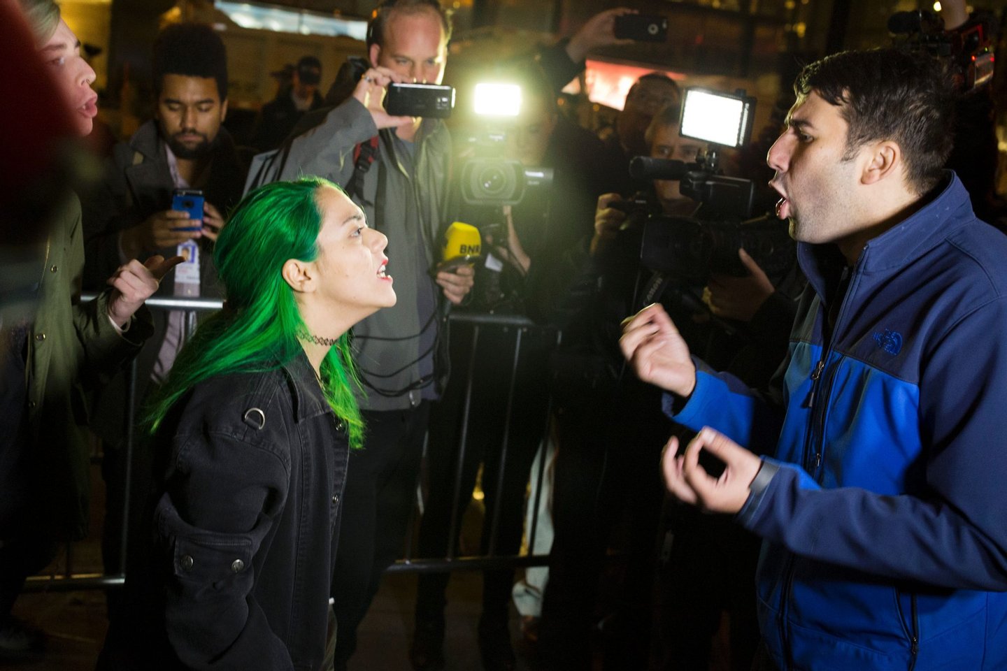 A protester argues with a supporter of Republican presidential nominee Donald Trump outside Trump Tower in New York City after midnight on election day November 9, 2016. Donald Trump stunned America and the world, riding a wave of populist resentment to defeat Hillary Clinton in the race to become the 45th president of the United States. The Republican mogul defeated his Democratic rival, plunging global markets into turmoil and casting the long-standing global political order, which hinges on Washington's leadership, into doubt. / AFP / DOMINICK REUTER (Photo credit should read DOMINICK REUTER/AFP/Getty Images)