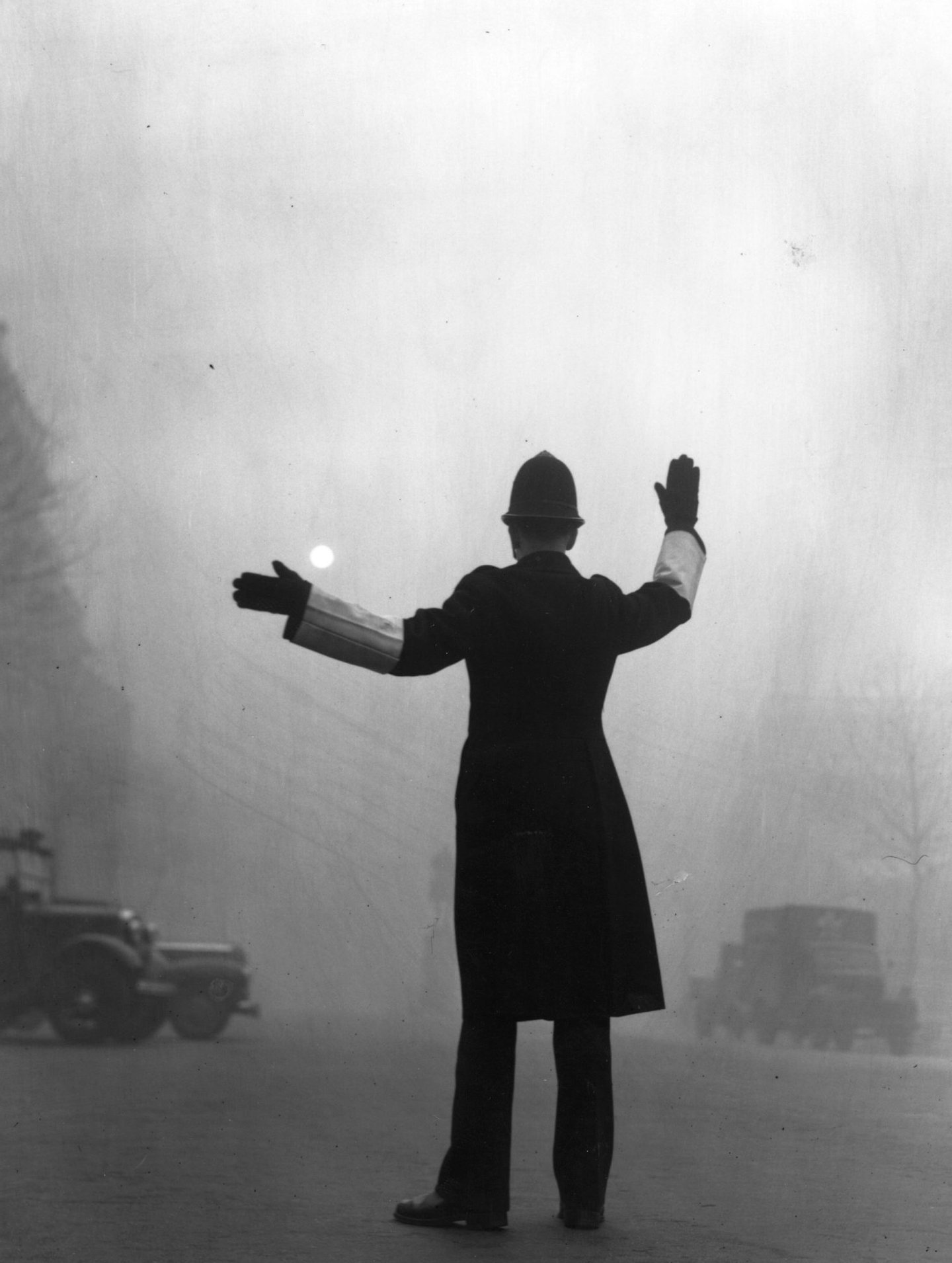 A policeman on traffic duty on a foggy day in Fleet Street, London. (Photo by Hulton Archive/Getty Images)
