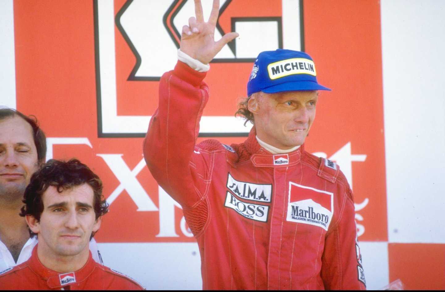 1984: Marlboro McLaren drivers Alain Prost of France and Niki Lauda of Austria stand on the winners'' podium after the Portuguese Grand Prix at the Estoril circuit in Portugal. Prost finished in first place and Lauda in second. Mandatory Credit: Mike Powell/Allsport