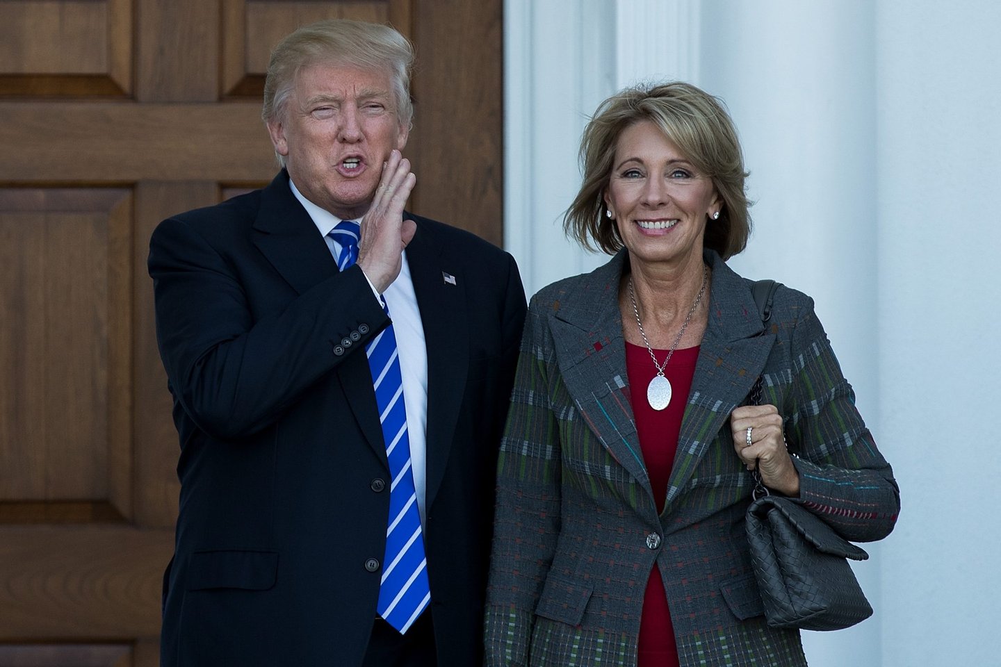 BEDMINSTER TOWNSHIP, NJ - NOVEMBER 19: (L to R) president-elect Donald Trump and Betsy DeVos pose for a photo after their meeting at Trump International Golf Club, November 19, 2016 in Bedminster Township, New Jersey. Trump and his transition team are in the process of filling cabinet and other high level positions for the new administration. (Photo by Drew Angerer/Getty Images)