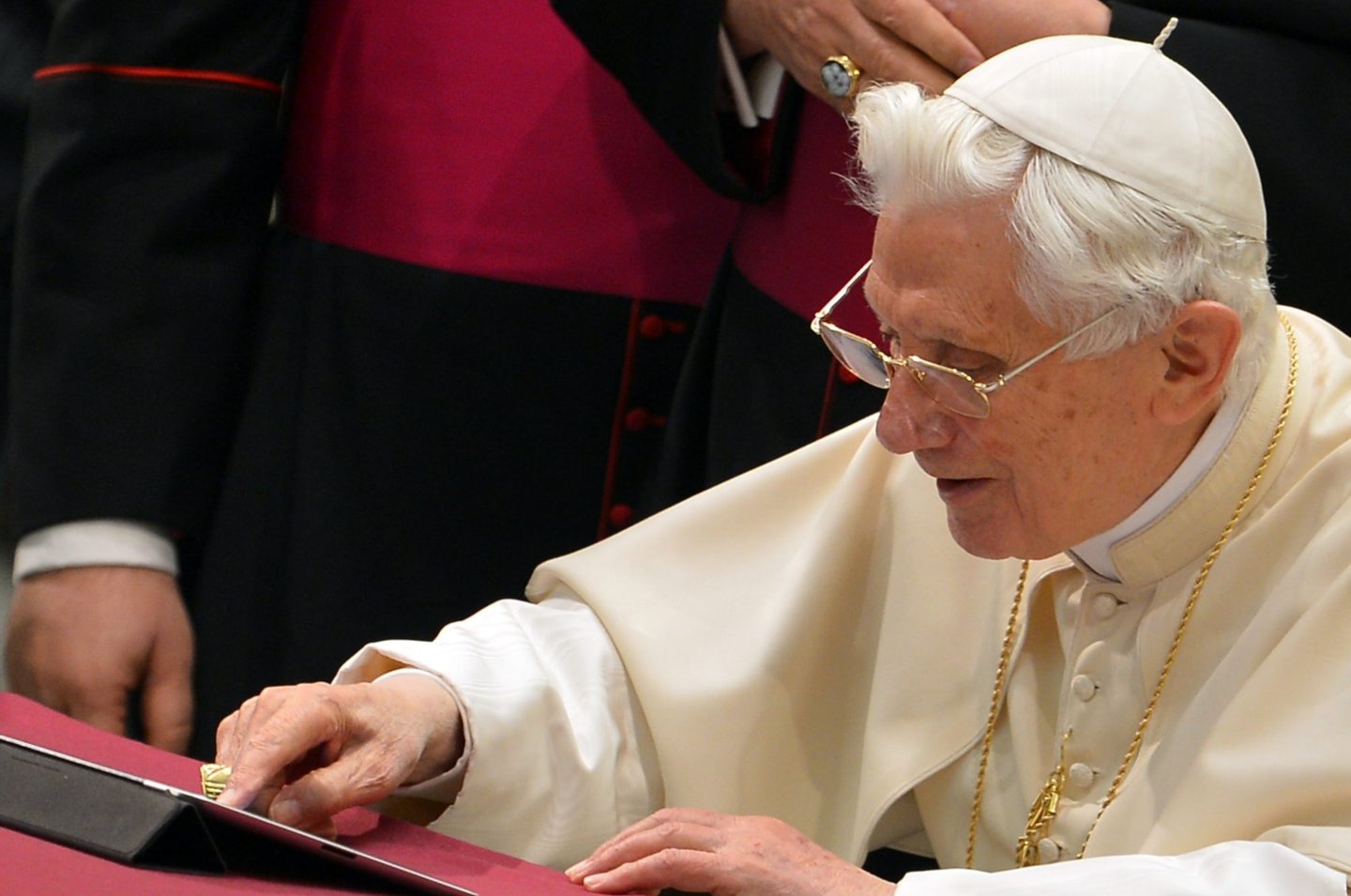 Pope Benedict XVI clicks on a tablet to send his first twitter message during his weekly general audience on December 12, 2012 at the Paul VI hall at the Vatican. Pope Benedict XVI sent his first Twitter message from a digital tablet on Wednesday using the handle @pontifex, blessing his hundreds of thousands of new Internet followers. AFP PHOTO / VINCENZO PINTO (Photo credit should read VINCENZO PINTO/AFP/Getty Images)