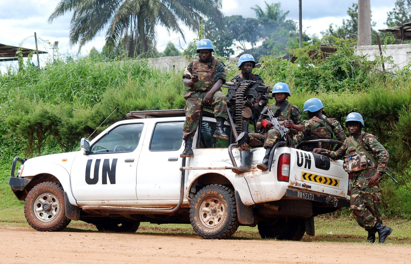 Blue helmet members of the United Nations Organization Stabilization Mission in the Democratic Republic of Congo MONUSCO sit on the back of a UN pick-up truck on October 23, 2014 in Beni. Several violent protests have erupted since October 21 in the east of the Democratic Republic of Congo to demand the departure of MONUSCO, accused of failing to prevent recent massacres in the Beni territory, attributed to Islamist Ugandan rebels of the Allied Democratic Forces (ADF), in which 80 civilians were killed in less than two weeks. AFP PHOTO / ALAIN WANDIMOYI (Photo credit should read ALAIN WANDIMOYI/AFP/Getty Images)