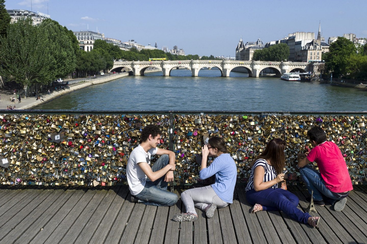 People gather at the "Pont des Arts" bridge on July 5, 2013 in Paris. AFP PHOTO / FRED DUFOUR (Photo credit should read FRED DUFOUR/AFP/Getty Images)