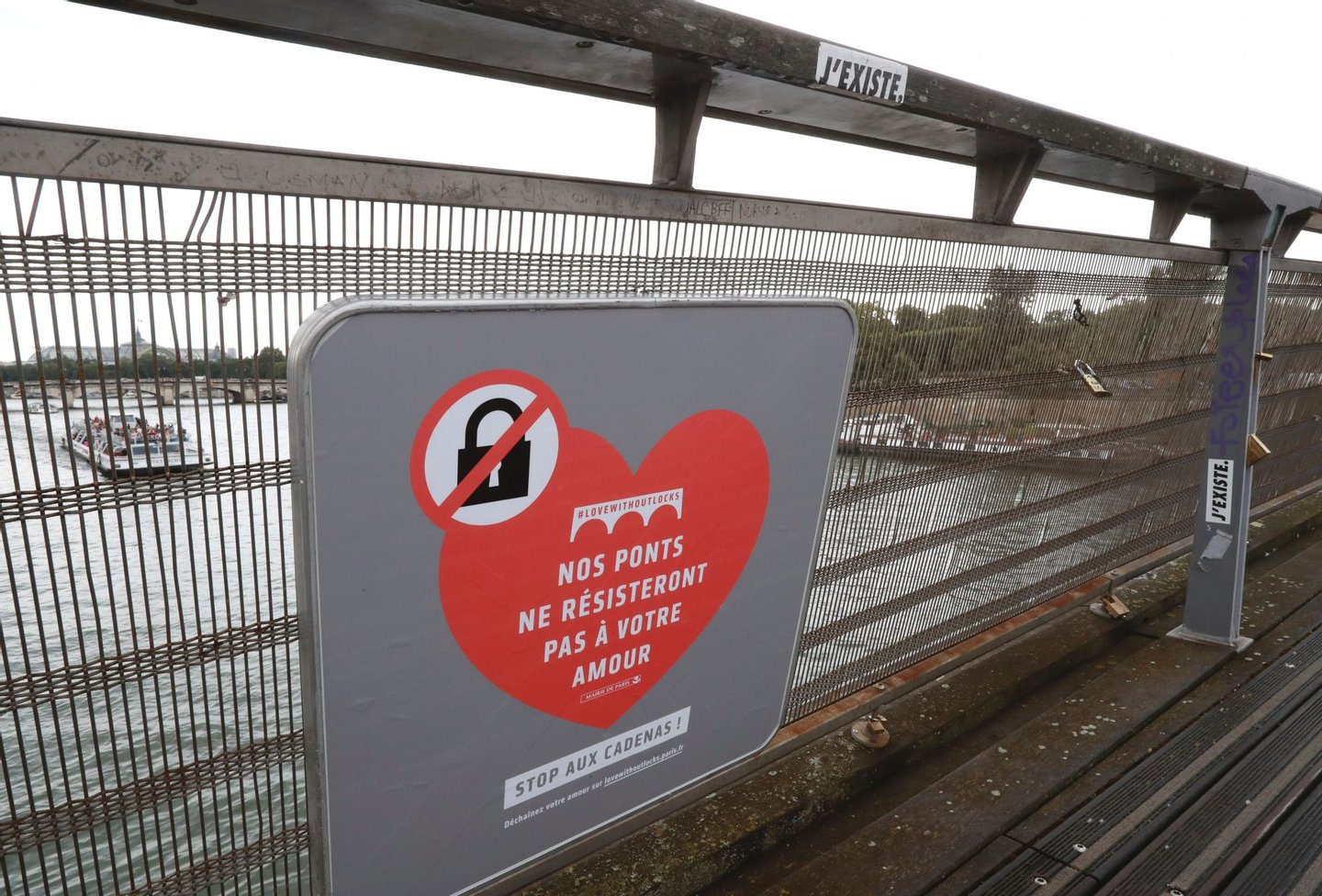 A placard reading "our bridges won't resist your love" is seen on the footbridge of Leopold-Sedar-Senghor in Paris, on August 4, 2016. Love may know no bounds, but Paris intends to instill some: authorities are going to take a tougher line with swooning couples attaching "love-locks" to city bridges as a sign of their undying devotion. In June last year authorities removed hundreds of thousands of such padlocks from the city bridges, notably the Pont des Arts which had a section collapse under the weight of the locks. / AFP / JACQUES DEMARTHON (Photo credit should read JACQUES DEMARTHON/AFP/Getty Images)