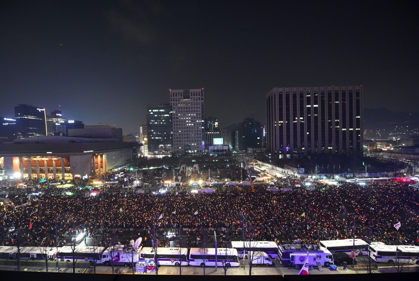 Protesters attend a candle-lit rally calling for South Korean President Park Geun-Hye's immediate departure from her office, in downtown Seoul on December 31, 2016. South Korea sees in the new year with a massive protest calling for an immediate arrest of impeached President Park Geun-Hye. / AFP / JUNG Yeon-Je (Photo credit should read JUNG YEON-JE/AFP/Getty Images)