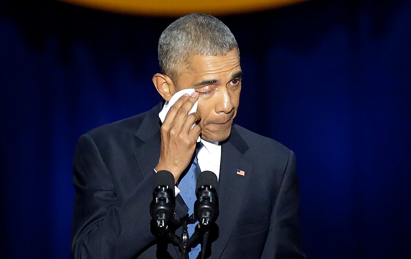 US President Barack Obama cries as he speaks during his farewell address in Chicago, Illinois on January 10, 2017. Barack Obama closes the book on his presidency, with a farewell speech in Chicago that will try to lift supporters shaken by Donald Trump's shock election. / AFP / Joshua LOTT (Photo credit should read JOSHUA LOTT/AFP/Getty Images)
