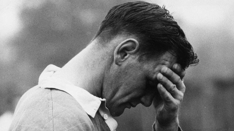 Brian Lochore caprain of the All Blacks, New Zealand rugger team rests his head in his hand after a strenuous training session at Wimbledon before a European tour. (Photo by Bob Aylott/Getty Images)