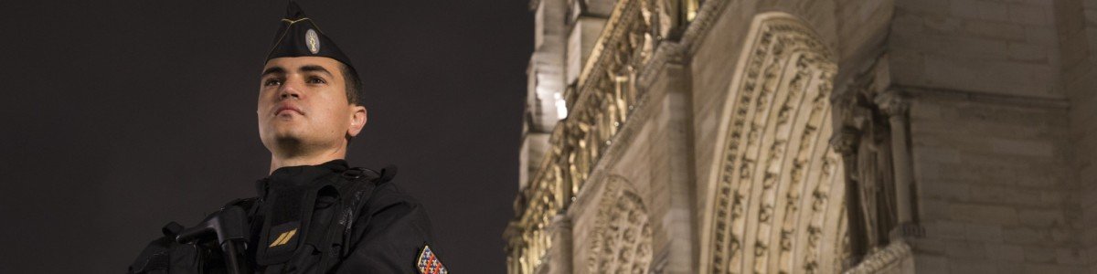 A French gendarme enforcing the Vigipirate plan, France's national security alert system, is pictured on November 19, 2015 in front of the Notre-Dame cathedral in Paris. France revealed on November 19 it will spend an extra 600 million euros (USD 641 million) next year to ramp up security after the Paris attacks. President Francois Hollande announced this week that France is freezing plans to cut troop numbers through 2019. At the same time, the country will add 8,500 law enforcement jobs including 5,000 new police. AFP PHOTO / JOEL SAGET (Photo credit should read JOEL SAGET/AFP/Getty Images)