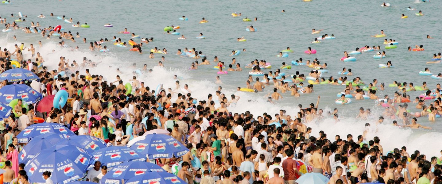SHENZHEN, CHINA - AUGUST 1: (CHINA OUT) Swimmers pack the Dameisha Bathing Beach on August 1, 2006 in Shenzhen of Guangdong Province, China. With the advent of the travel season, bathing beaches in the city have become major tourist attractions. (Photo by China Photos/Getty Images)