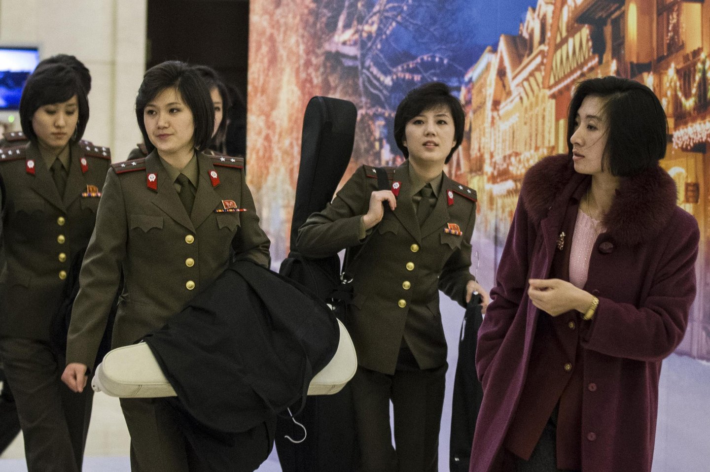 This picture taken on December 10, 2015 shows members of North Korea's Moranbong band walking out of their hotel in Beijing. North Korea's premier pop group, the all-girl Moranbong band formed by leader Kim Jong-Un, is electrifying audiences in China in shows aimed at harmonising out-of-tune ties between the traditional allies, reports and the venue said on December 9 -- but tickets are not available to the public. CHINA OUT AFP PHOTO / AFP / STR (Photo credit should read STR/AFP/Getty Images)