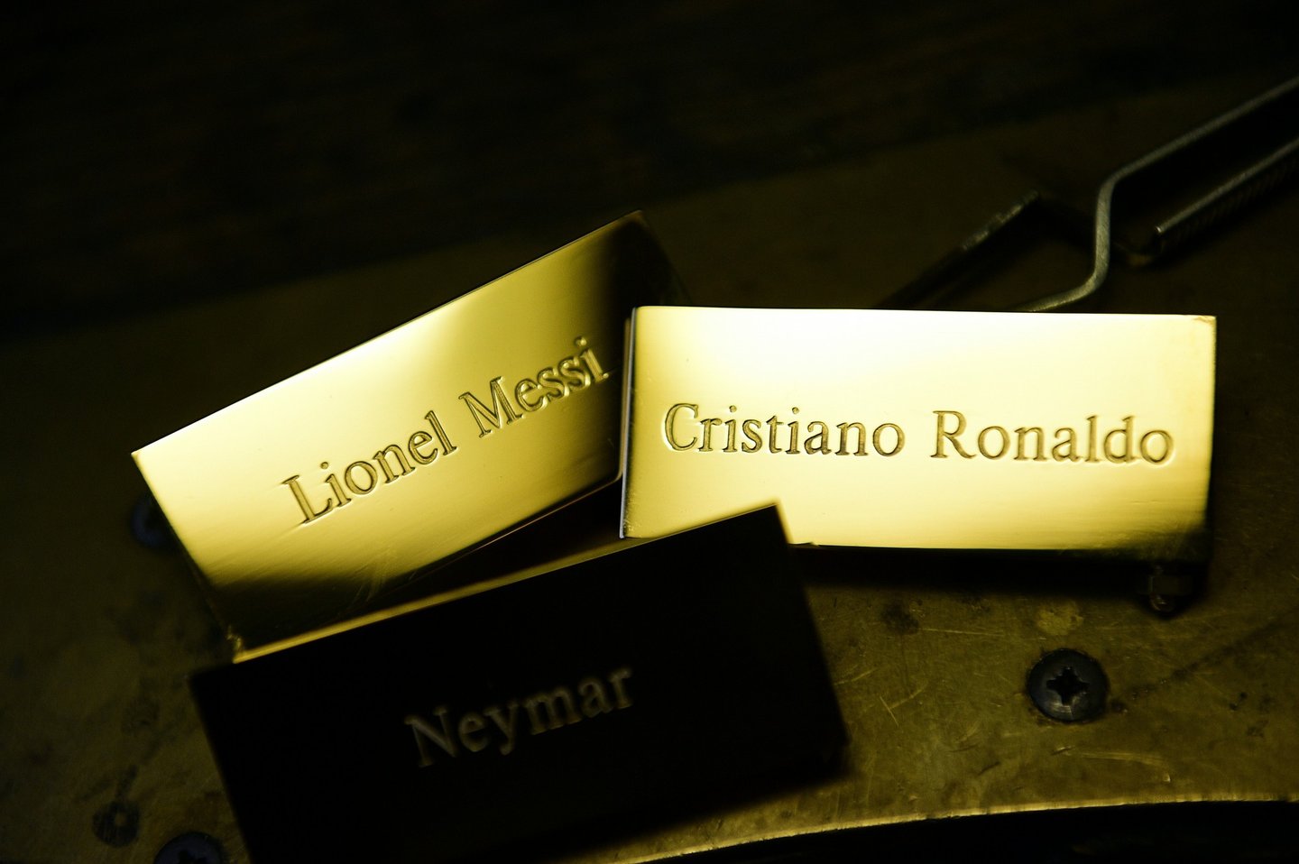 A picture taken on December 15, 2015 shows three plaques reading, "Cristiano Ronaldo", "Lionel Messi" and "Neymar" at the Mellerio jewellers in Paris, as part of the crafting of the Ballon d'Or 2015 Fifa award. Barcelona's Argentinian forward Lionel Messi, Barcelona's Brazilian forward Neymar and Real Madrid's Portuguese forward Cristiano Ronaldo were shortlisted for the Ballon d'Or 2015, Fifa's annual football award given to the male player considered to have performed the best in the previous calendar year, and that will be awarded on January 11, 2016 during a gala event in Zurich. / AFP / FRANCK FIFE (Photo credit should read FRANCK FIFE/AFP/Getty Images)