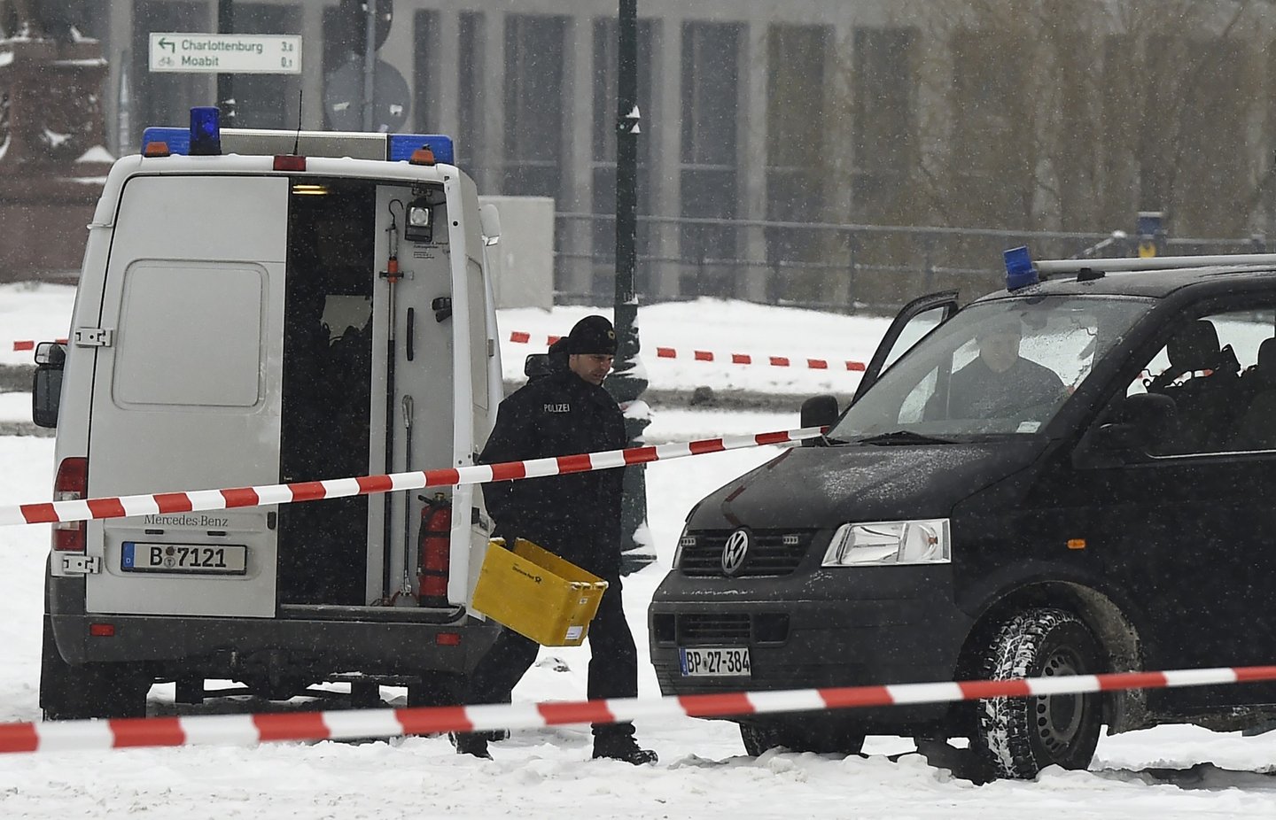 A policeman carries a post box through a blocked area in front of the Chancellery in Berlin on January 6, 2016, as a suspicious mail was found. The German cabinet is to hold it's weekly meeting at the Chancellery. / AFP / TOBIAS SCHWARZ (Photo credit should read TOBIAS SCHWARZ/AFP/Getty Images)