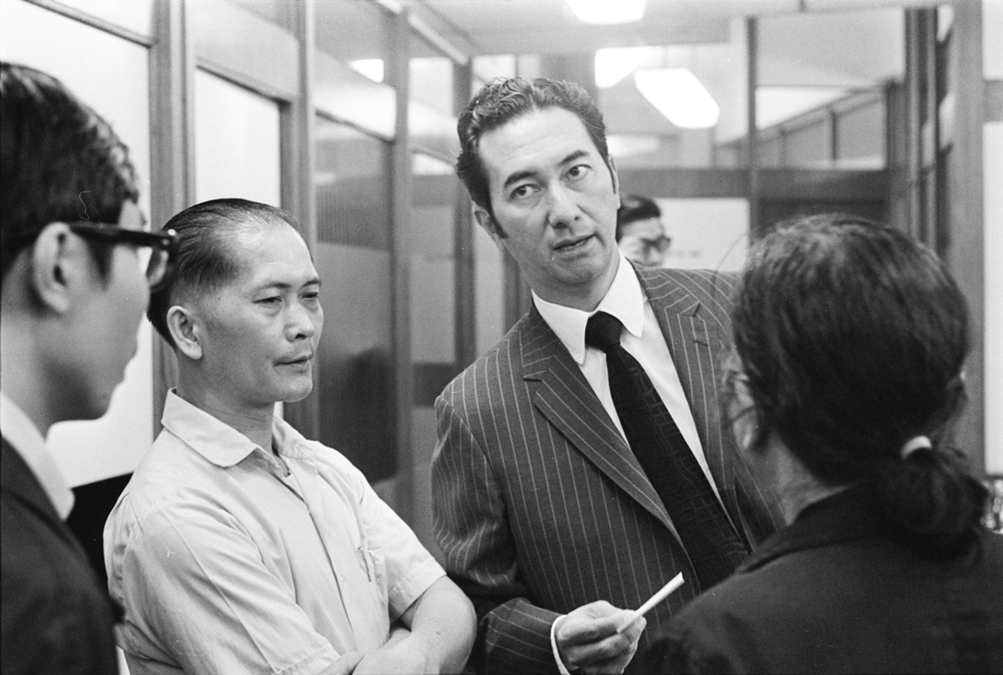 Black and white photo of Stanley Ho with relatives of Fatshan's crew. Fatshan was a Macau-Hong Kong ferry that capsized off Lantau Island when Typhoon Rose hit the territory on 17 August 1971.