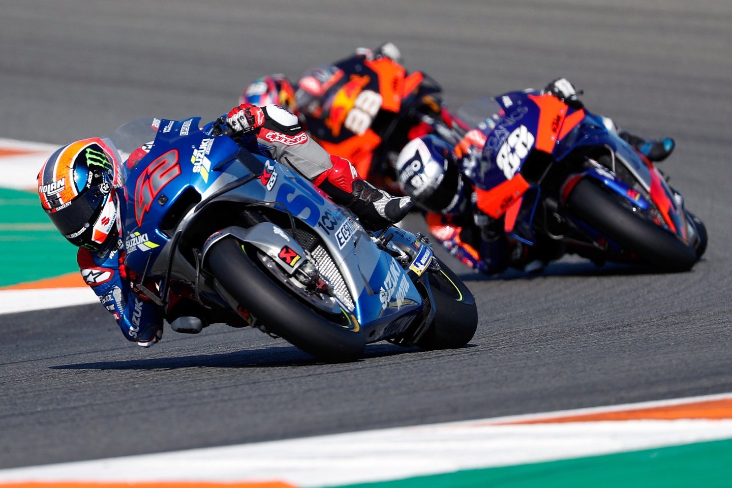 epa08821922 Spanish MotoGP rider Alex Rins (L) takes a bend ahead of Portuguese Miguel Oliveira (R) and South African Brad Binder (C, rear) during the Motul Comunitat Valenciana GP race at Circuit Ricardo Tormo track, in Cheste, Valencia, eastern Spain, 15 November 2020. EPA/Kai Foersterling