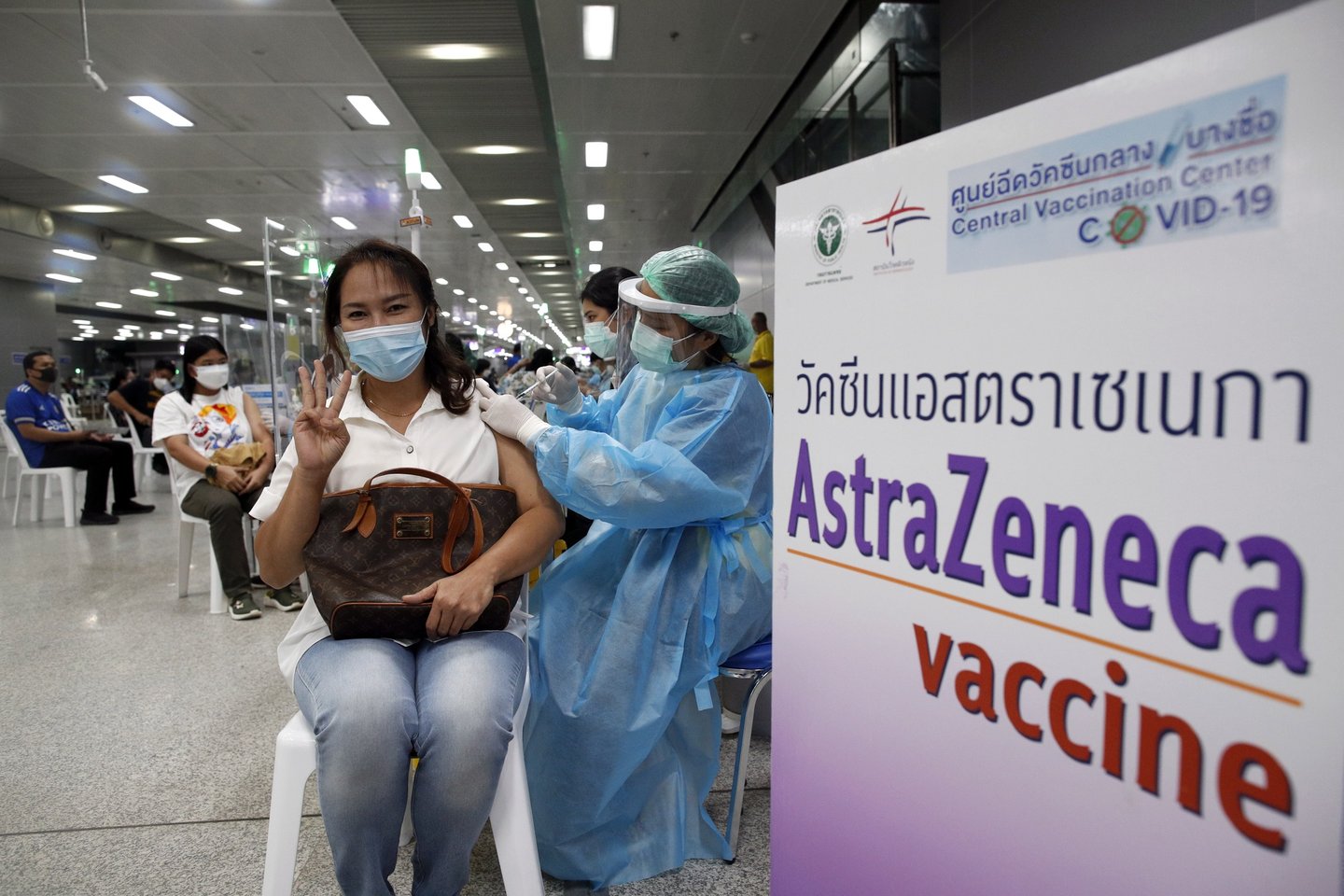 epa09485160 A Thai woman gestures while receiving a dose of AstraZeneca (Vaxzevria) vaccine for the third booster vaccination against COVID-19 at Bang Sue Central Vaccination Center in Bangkok, Thailand, 24 September 2021. Thailand rolled out third vaccination injections as a booster shot against COVID-19 for the public with AstraZeneca (Vaxzevria) vaccine amid the prolonged surge of COVID-19 infections. The Thai government plans to fully vaccinate 50 million people by the end of 2021, according to the Health Minister. EPA/RUNGROJ YONGRIT (RESEND)