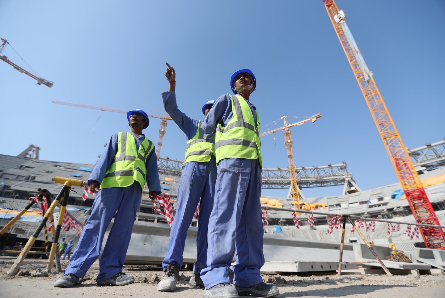 epa08083065 Construction workers at Lusail Stadium during a media tour in Doha, Qatar, 20 December 2019. Lusail Stadium is one of the eight stadiums build for the FIFA World Cup 2022 in Qatar. EPA/ALI HAIDER