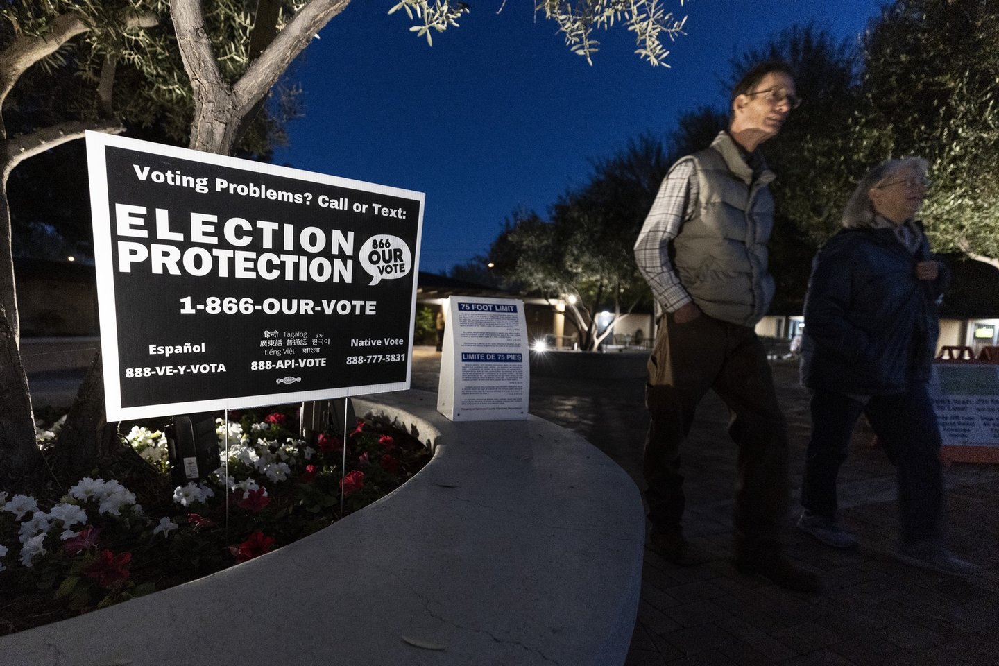 epa10293914 Voters walk past a sign reading ‘Election Protection’ after casting their ballots at the Dayspring United Methodist Church in Tempe, Arizona, USA, 08 November 2022. The US midterm elections are held every four years at the midpoint of each presidential term and this year include elections for all 435 seats in the House of Representatives, 35 of the 100 seats in the Senate and 36 of the 50 state governors as well as numerous other local seats and ballot issues. EPA/ETIENNE LAURENT